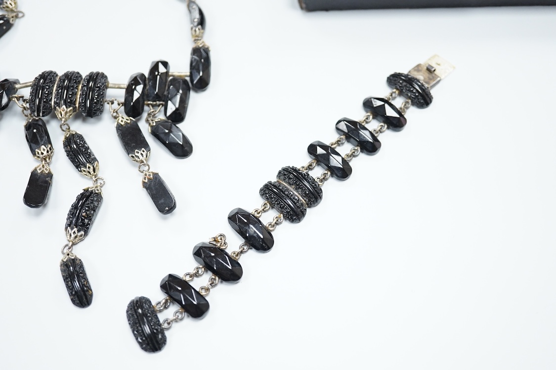 A small group of assorted Whitby jet jewellery including a matching bracelet and necklace, etc.